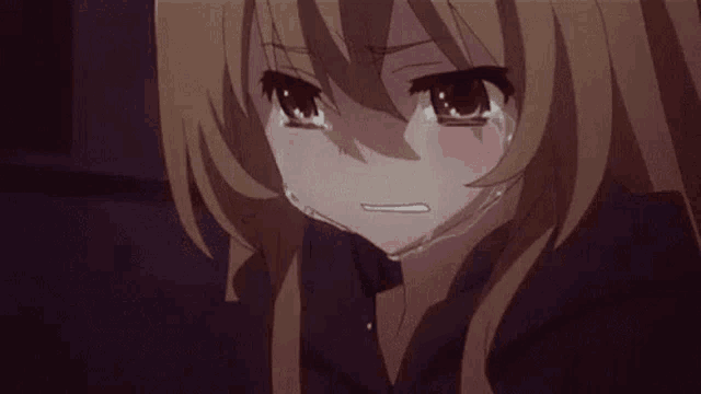 a close up of a sad anime girl crying with tears running down her face .