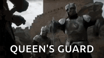 a group of knights in armor are standing next to each other in front of a wall .