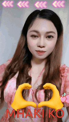 a woman in a pink dress is making a heart with her hands and the name mhakiko is on the bottom