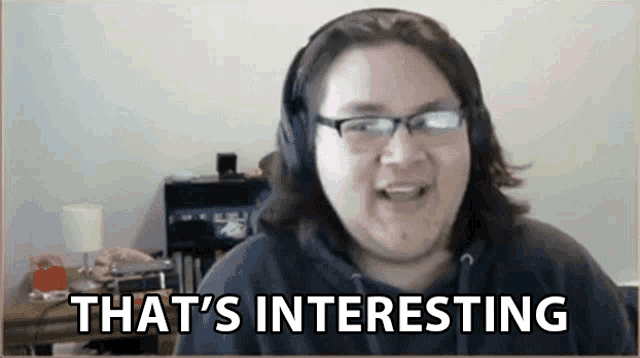 a man wearing headphones and glasses says " that 's interesting "