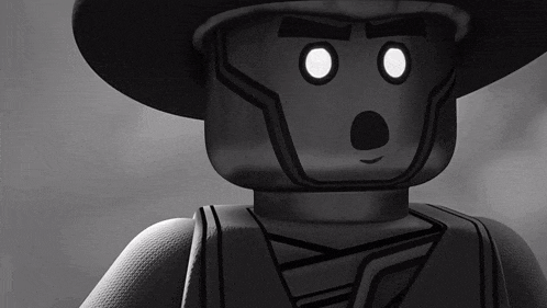 a black and white photo of a lego figure with a surprised look on his face