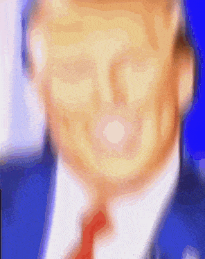 a blurry picture of a man 's face with a blue background