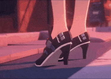 a close up of a person 's feet wearing high heels