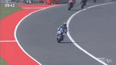 a man riding a motorcycle on a race track with the time 9:36