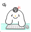 a cartoon rabbit is sitting at a desk with a keyboard and mouse .