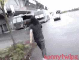 a person is running down a street with sonny twipz written in red