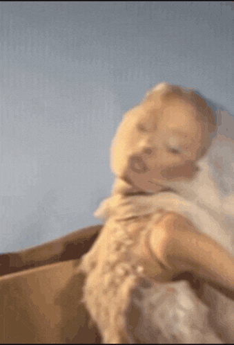 a blurry picture of a baby being held by a person