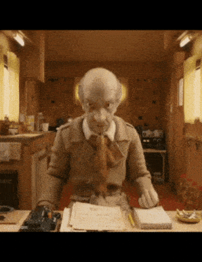 a cartoon character is sitting at a desk with a notebook and a pen