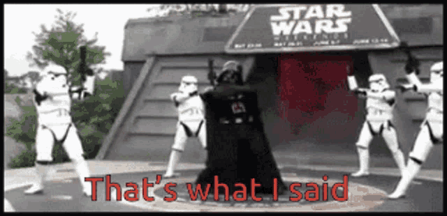 a group of stormtroopers are dancing in front of a sign for star wars