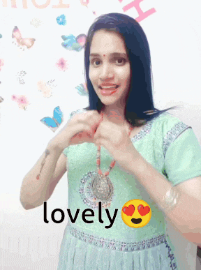a woman is wearing a necklace with the word lovely written on it
