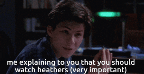 a young man smoking a cigarette with the words me explaining to you that you should watch heathers very important