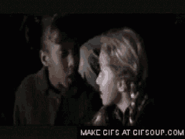 two young girls are looking at each other in a dark room with the words make gifs at gifsoup.com on the bottom
