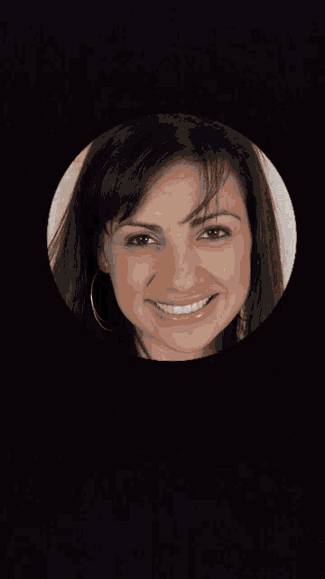 a woman in a black top is smiling in a circle on a black background