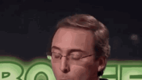a man wearing glasses is making a funny face .