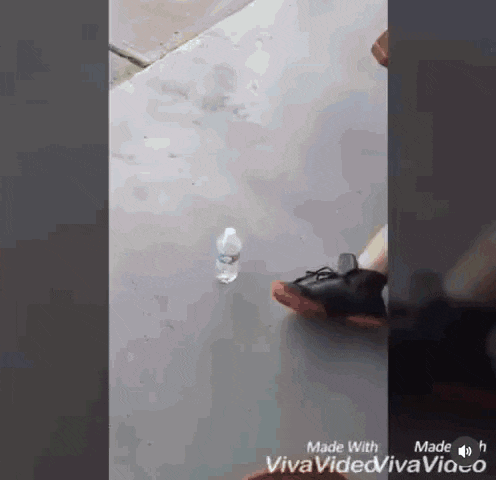 a bottle of water is on the ground in a video made with viva video