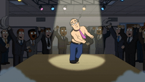 a man without a shirt is being spotlighted in front of a crowd of people