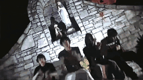 a group of people are sitting in front of a statue of jesus