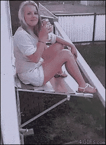 a woman is sitting on a balcony with a glass of wine