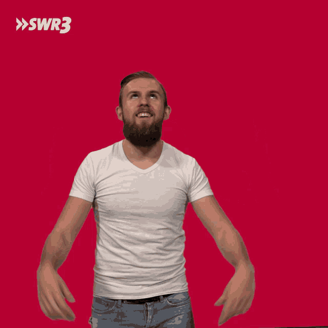 a man in a white shirt is raising his hands in the air with a swr3 logo in the background