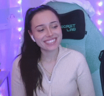 a woman is sitting in a chair with a secret lab pillow on it