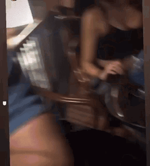 a blurry picture of a woman sitting in a chair
