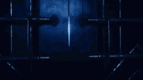 a person is standing in a dark room with blue smoke coming out of the ceiling .