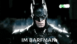 a close up of a man in a batman costume with the words `` im barfman '' written on it .