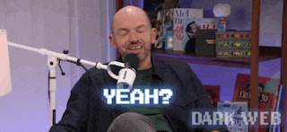 a bald man is sitting in front of a microphone with his eyes closed and says yeah .