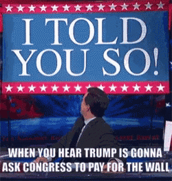 a man is sitting in front of a sign that says i told you so