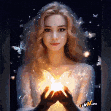 a woman in a white dress is holding a light in her hands
