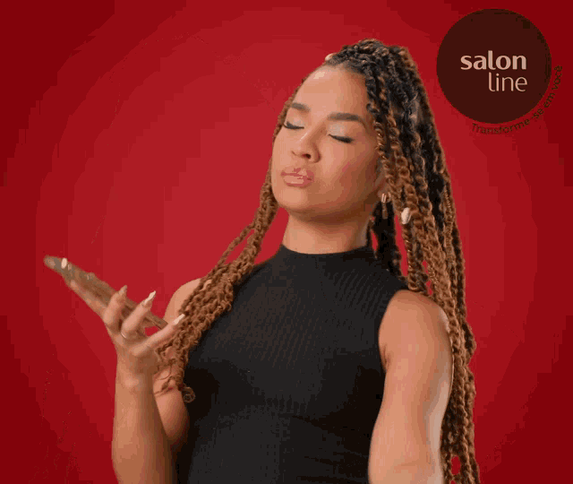 a woman is talking on a cell phone with a salon line logo in the background