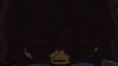 a yellow glowing object in a dark room with a checkered wall