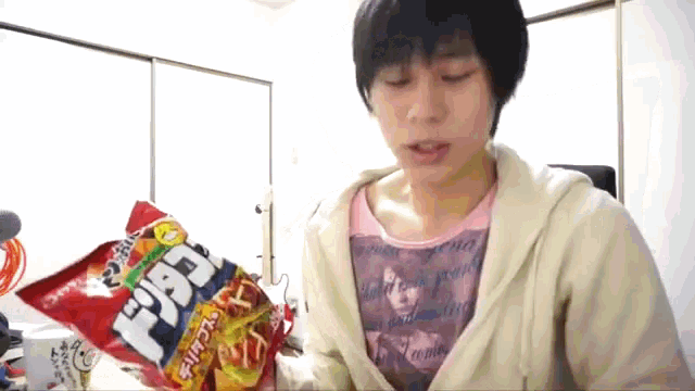 a person is holding a bag of doritos in their hand