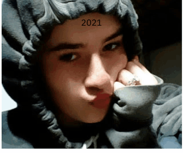 a young girl wearing a hoodie with the year 2021 on her forehead