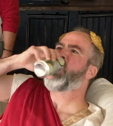 a man with a beard is drinking a can of beer