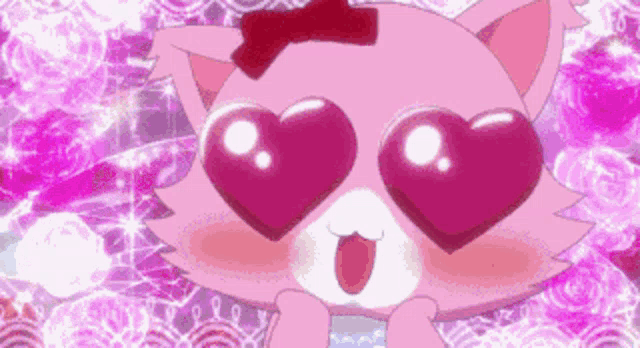 a pink cat with heart shaped eyes and a red bow on its head