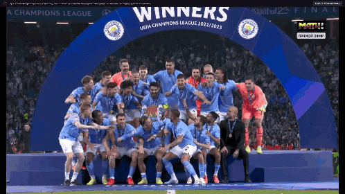 a group of soccer players are posing for a picture under a banner that says winners