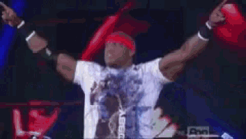 a man with his arms outstretched is wearing a red headband and a white shirt that says pop