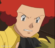 a cartoon character with red hair is wearing a yellow shirt and black gloves .