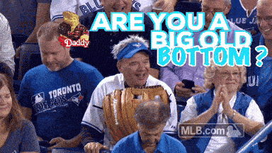 a man in a toronto blue jays shirt sits in a crowd of people