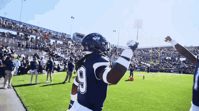 a football player with the number 9 on his jersey stands on the field