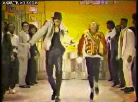 a group of people are dancing in front of a sign that says mxkrctmdlx.com
