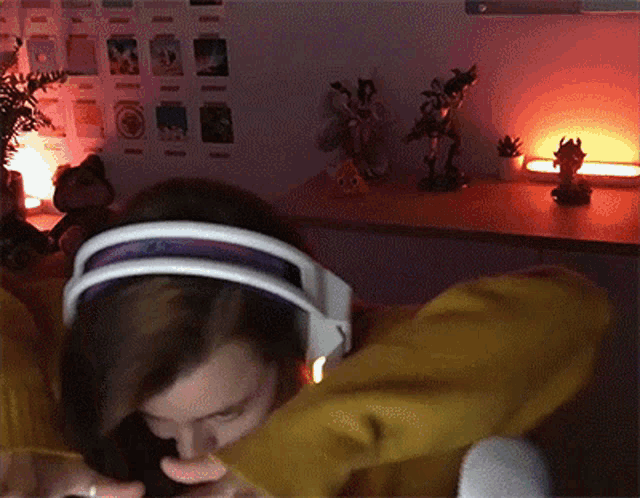 a woman wearing headphones is smoking a cigarette .
