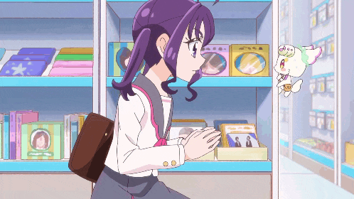 a girl with purple hair is standing in front of a shelf with a picture of a man on it