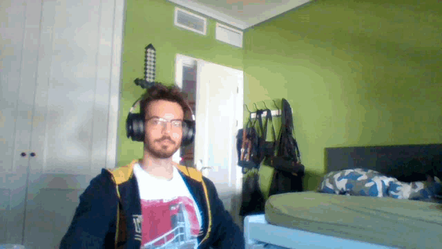 a man wearing headphones and a t-shirt that says ' tf ' on it