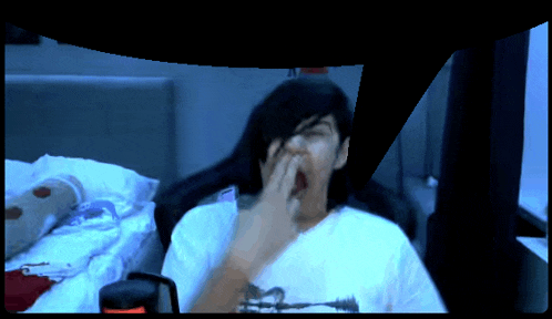 a person wearing a white shirt with a picture of a man on it yawning