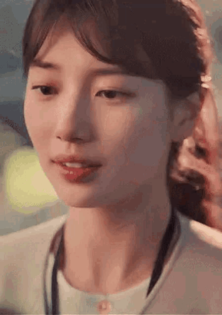 a close up of a woman 's face with her eyes closed and her mouth open .