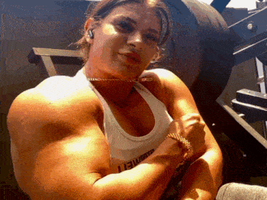 a woman flexing her muscles wearing a tank top with the word lewis on it