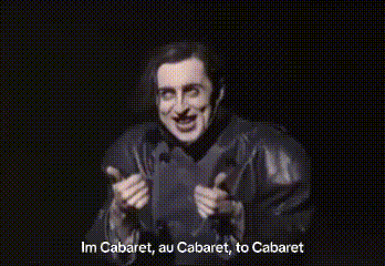 a man with his arms outstretched says im cabaret , au cabaret , to cabaret .