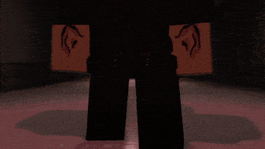 a person in a video game standing in front of an exit sign